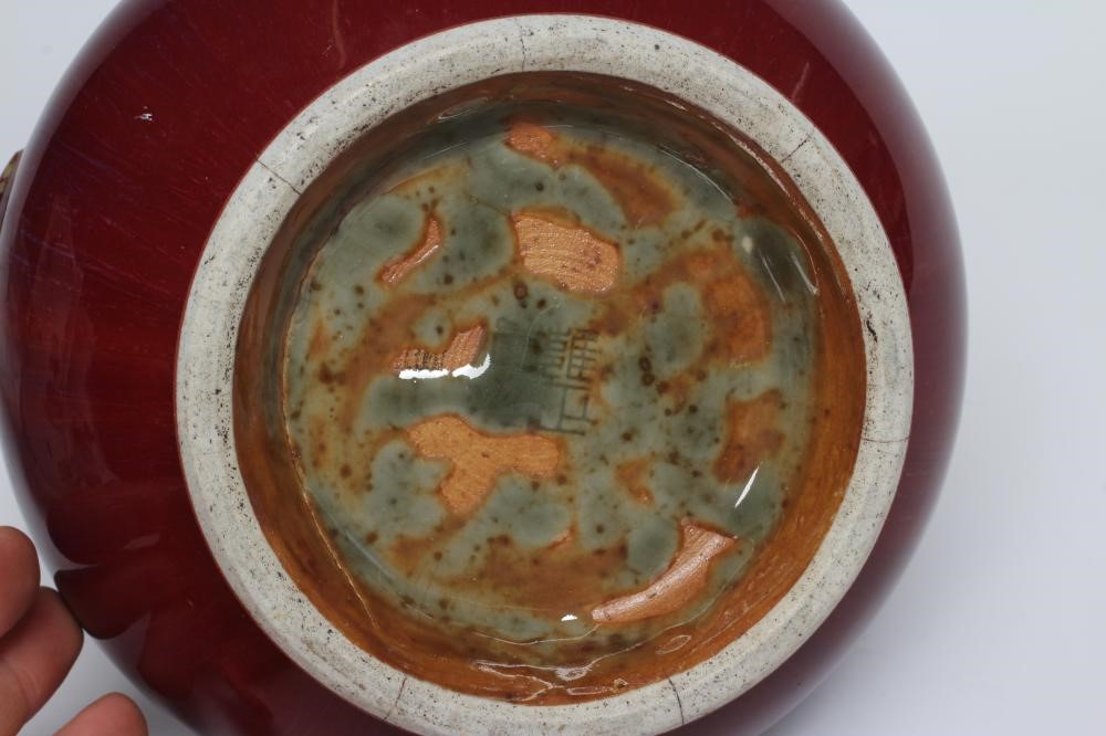 A CHINESE SANG DE BOEUF GLAZED VASE of baluster form with two fixed ring and tassel 'handles' Image