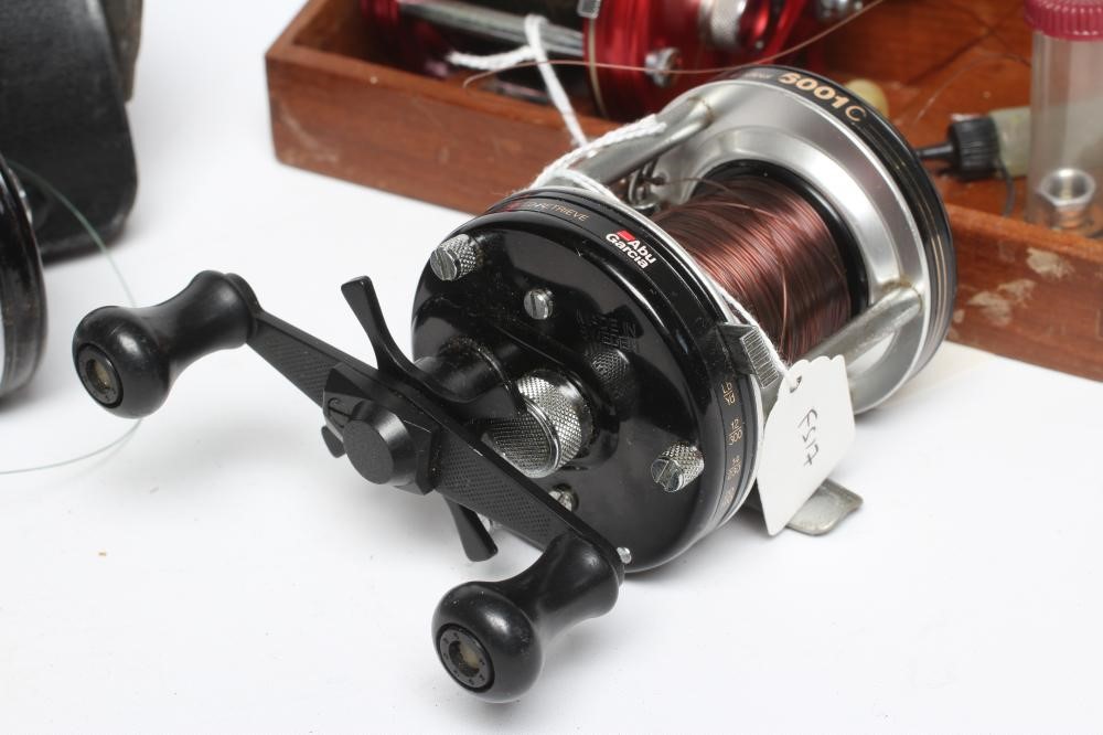 THREE AMBASSADEUR FISHING REELS, comprising one 6000, one 6001C and one 6000C, with one wooden case Image