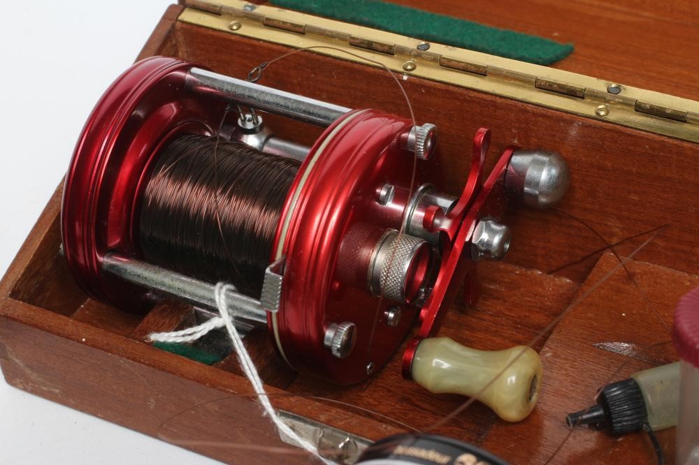 THREE AMBASSADEUR FISHING REELS, comprising one 6000, one 6001C and one 6000C, with one wooden case Image