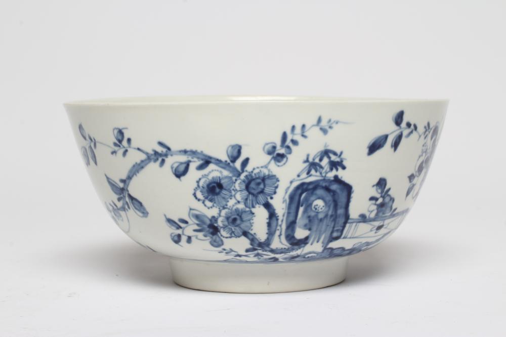 A FIRST PERIOD WORCESTER PORCELAIN BOWL, c.1755-60, painted in underglaze blue with the Prunus Fence Image