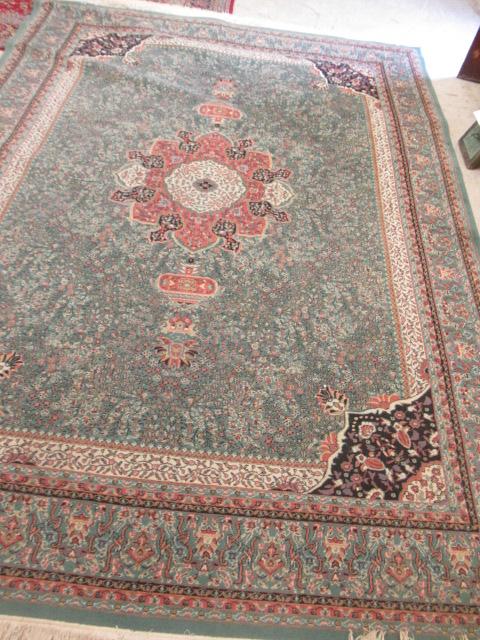 A TURKISH CARPET, modern, the pale green floral ground with central gul in pink, ivory and black Image