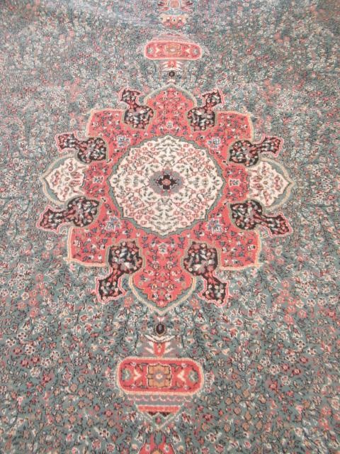 A TURKISH CARPET, modern, the pale green floral ground with central gul in pink, ivory and black Image