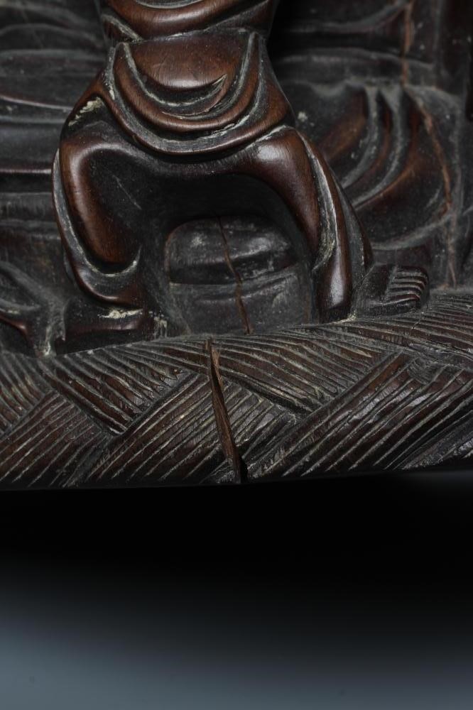 A CHINESE CARVED HARDWOOD BUDDAH, seated wearing a long bead necklace and with three children in Image