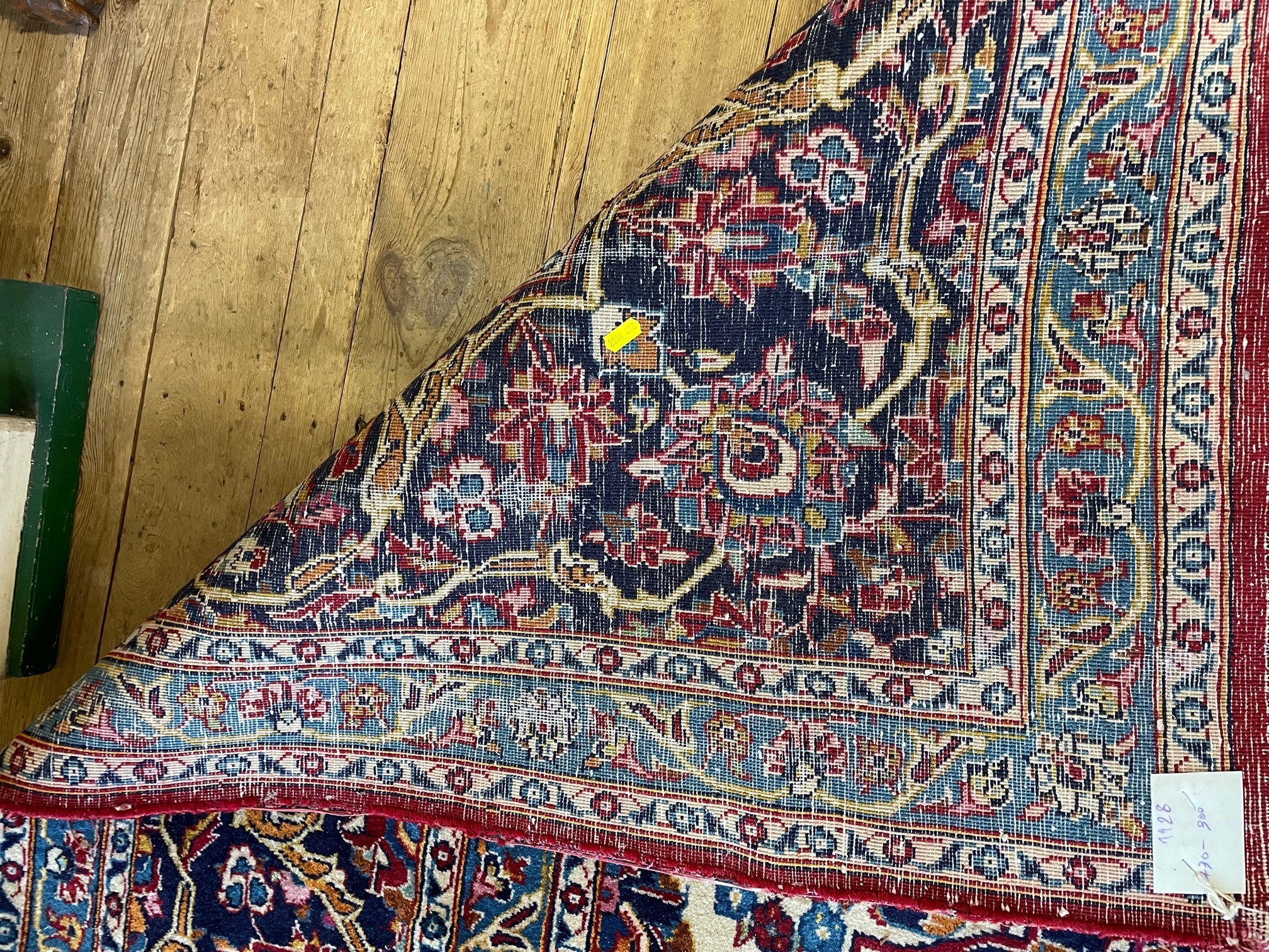 A KASHAN CARPET, the crimson floral field centred by an ivory and blue gul, similar spandrels within Image