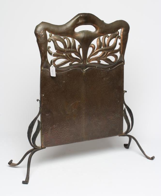 AN ARTS AND CRAFTS COPPER FIRESCREEN, of arched oblong form pierced with foliate panels, similar end Image