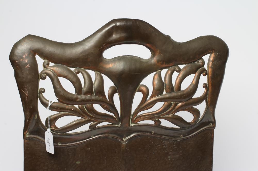 AN ARTS AND CRAFTS COPPER FIRESCREEN, of arched oblong form pierced with foliate panels, similar end Image