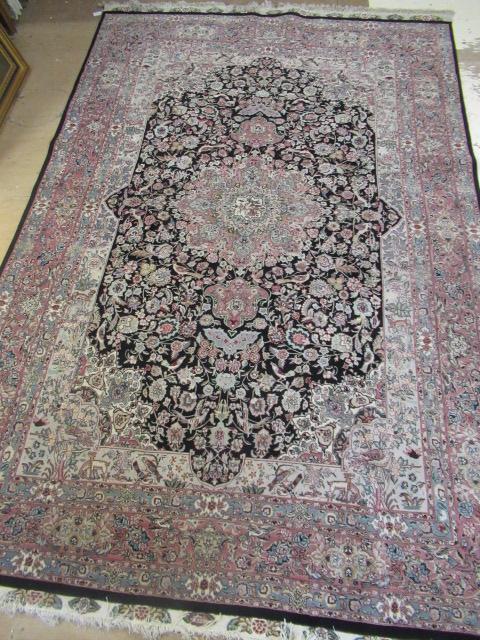 A PERSIAN RUG, the black floral field with rose pink gul and ivory spandrels within a pale blue Image
