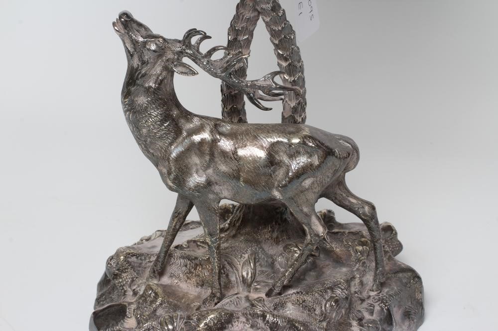 A VICTORIAN CUT GLASS AND PLATED CENTREPIECE with palm tree and deer on a rocky base, 19" high (Est. Image