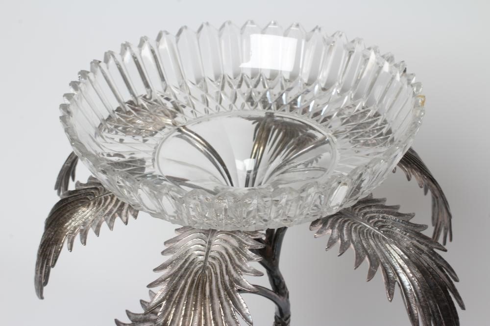 A VICTORIAN CUT GLASS AND PLATED CENTREPIECE with palm tree and deer on a rocky base, 19" high (Est. Image