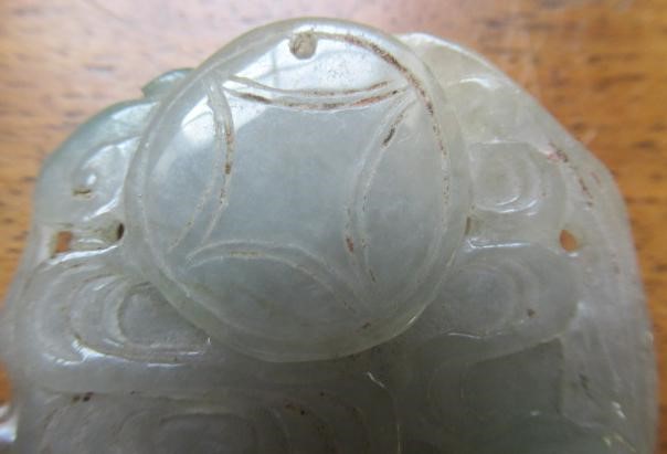 A CHINESE TWO TONE JADE PANEL carved and pierced with a man holding a cup Image