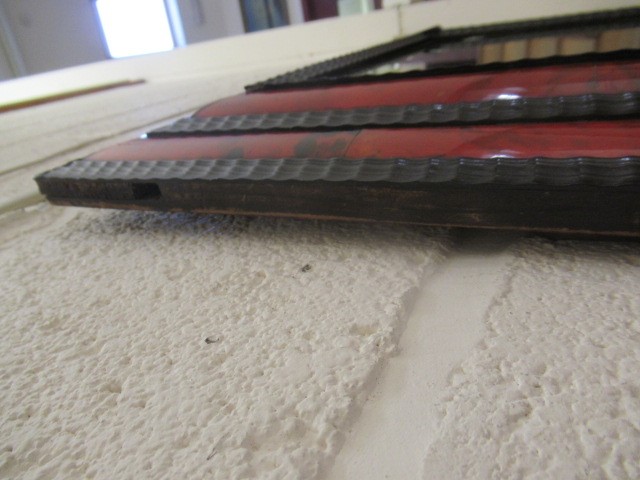 A RED TORTOISESHELL AND EBONY(?) WALL MIRROR of 17th century design, 19th century, the oblong plate Image