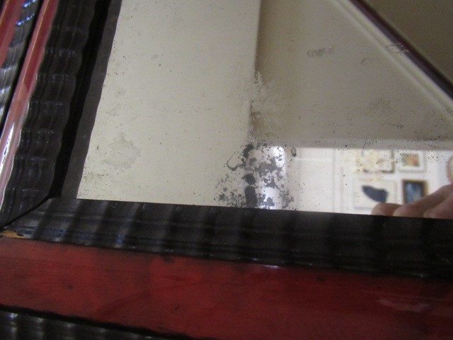 A RED TORTOISESHELL AND EBONY(?) WALL MIRROR of 17th century design, 19th century, the oblong plate Image