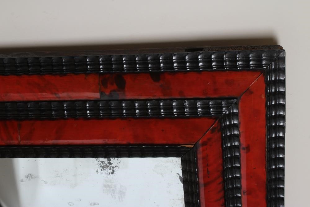 A RED TORTOISESHELL AND EBONY(?) WALL MIRROR of 17th century design, 19th century, the oblong plate Image