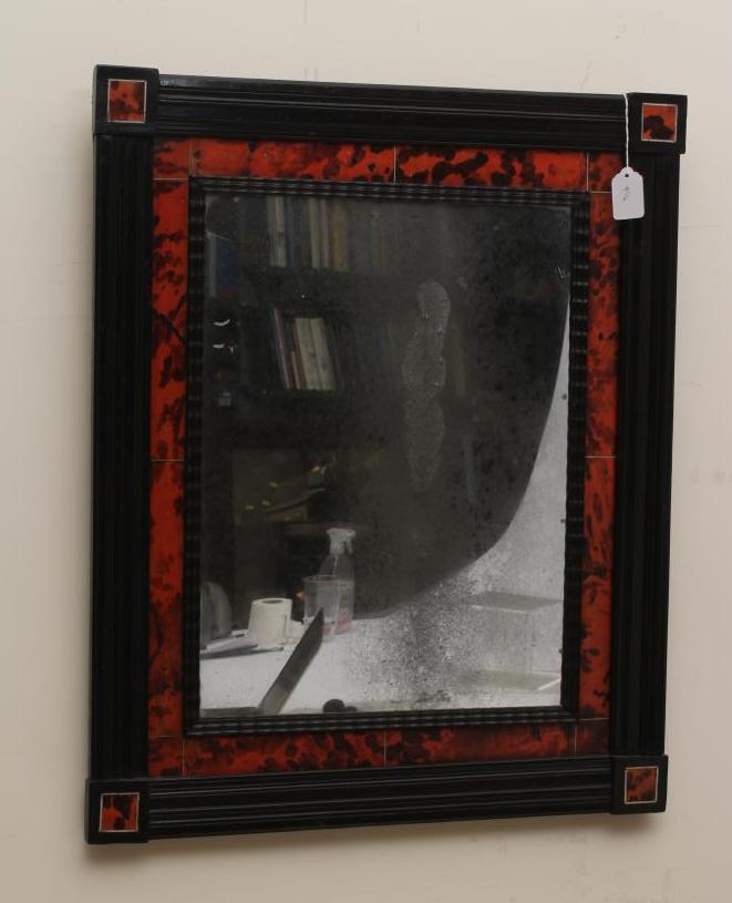 A RED TORTOISESHELL AND EBONY WALL MIRROR Image
