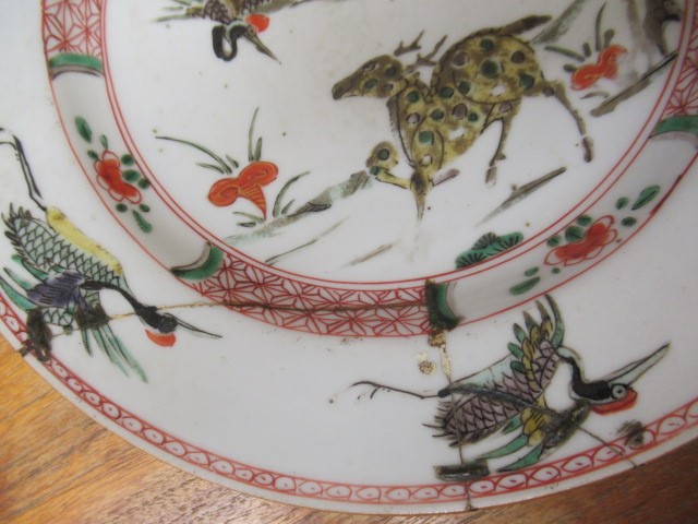 A GRADUATED PAIR OF CHINESE PORCELAIN CHARGERS of plain circular form painted in coloured enamels Image