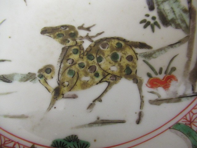 A GRADUATED PAIR OF CHINESE PORCELAIN CHARGERS of plain circular form painted in coloured enamels Image