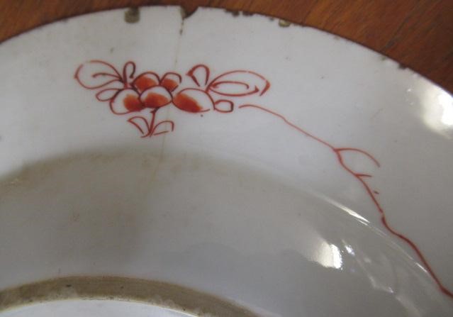 A GRADUATED PAIR OF CHINESE PORCELAIN CHARGERS of plain circular form painted in coloured enamels Image