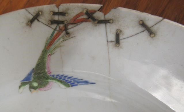 A GRADUATED PAIR OF CHINESE PORCELAIN CHARGERS of plain circular form painted in coloured enamels Image