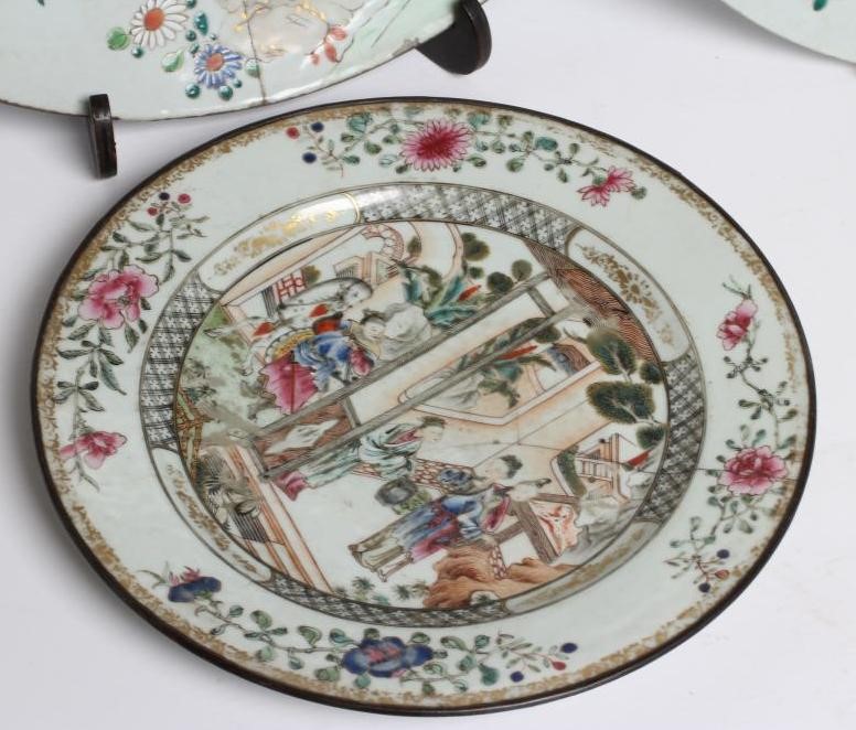 A GRADUATED PAIR OF CHINESE PORCELAIN CHARGERS of plain circular form painted in coloured enamels Image