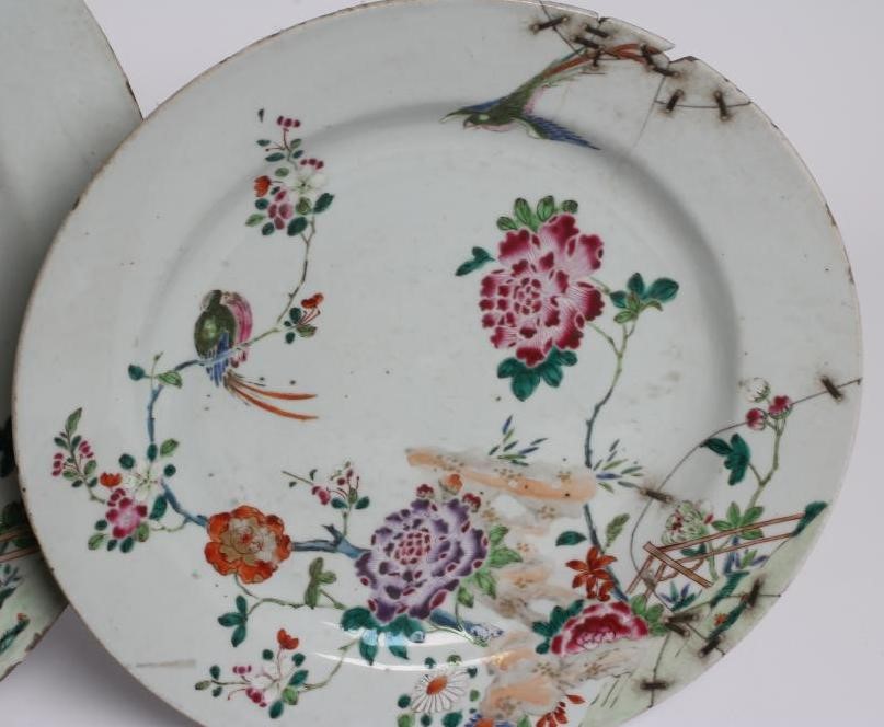A GRADUATED PAIR OF CHINESE PORCELAIN CHARGERS of plain circular form painted in coloured enamels Image