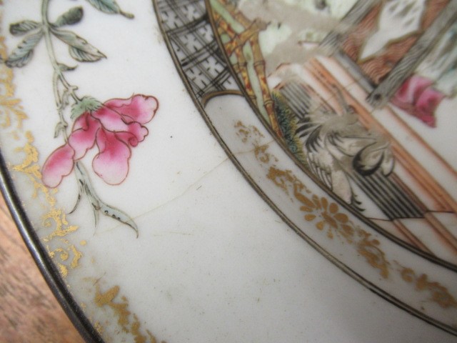 A GRADUATED PAIR OF CHINESE PORCELAIN CHARGERS of plain circular form painted in coloured enamels Image