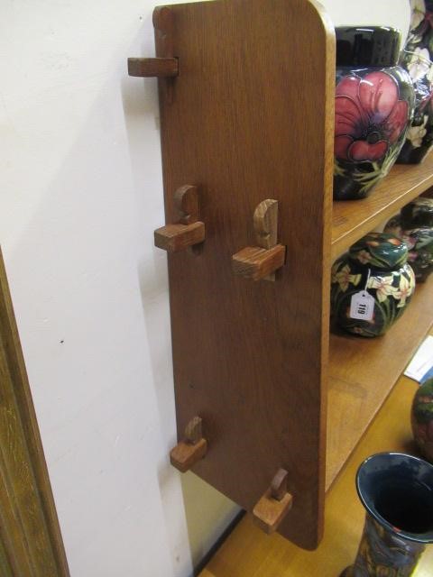A BOB HUNTER (THIRLBY) OAK WALL PLATE RACK, comprising two shelves tenoned into tapering ends, Image