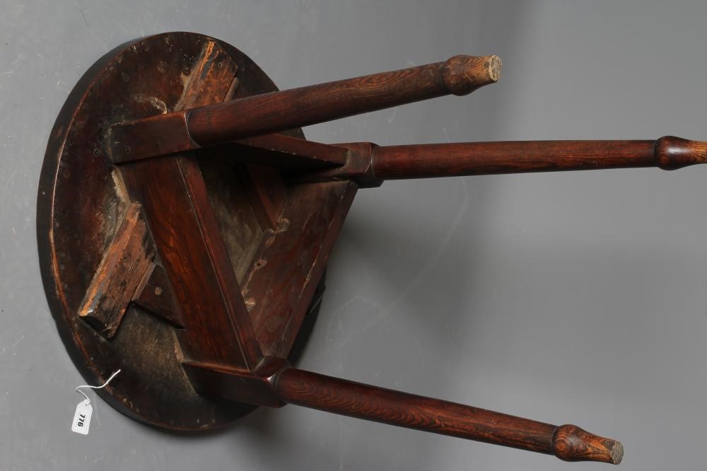AN OAK AND FRUITWOOD(?) CRICKET TABLE, 19th century, the heavy circular top on turned tapering legs Image