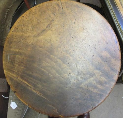 AN OAK AND FRUITWOOD(?) CRICKET TABLE, 19th century, the heavy circular top on turned tapering legs Image