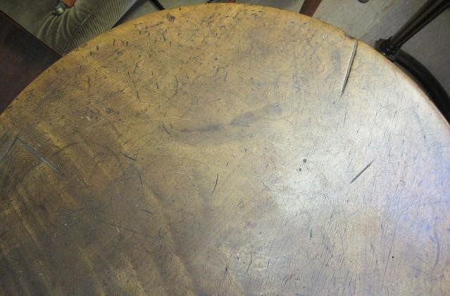 AN OAK AND FRUITWOOD(?) CRICKET TABLE, 19th century, the heavy circular top on turned tapering legs Image