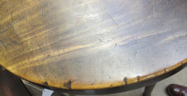 AN OAK AND FRUITWOOD(?) CRICKET TABLE, 19th century, the heavy circular top on turned tapering legs Image