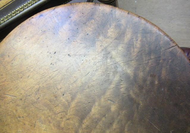 AN OAK AND FRUITWOOD(?) CRICKET TABLE, 19th century, the heavy circular top on turned tapering legs Image