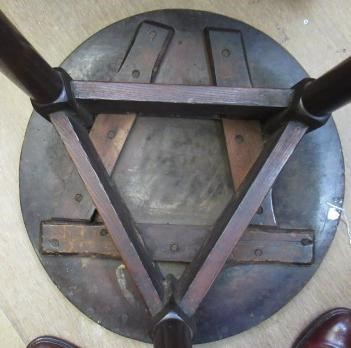 AN OAK AND FRUITWOOD(?) CRICKET TABLE, 19th century, the heavy circular top on turned tapering legs Image