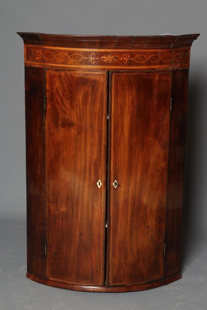 A GEORGE III MAHOGANY CORNER CUPBOARD Image