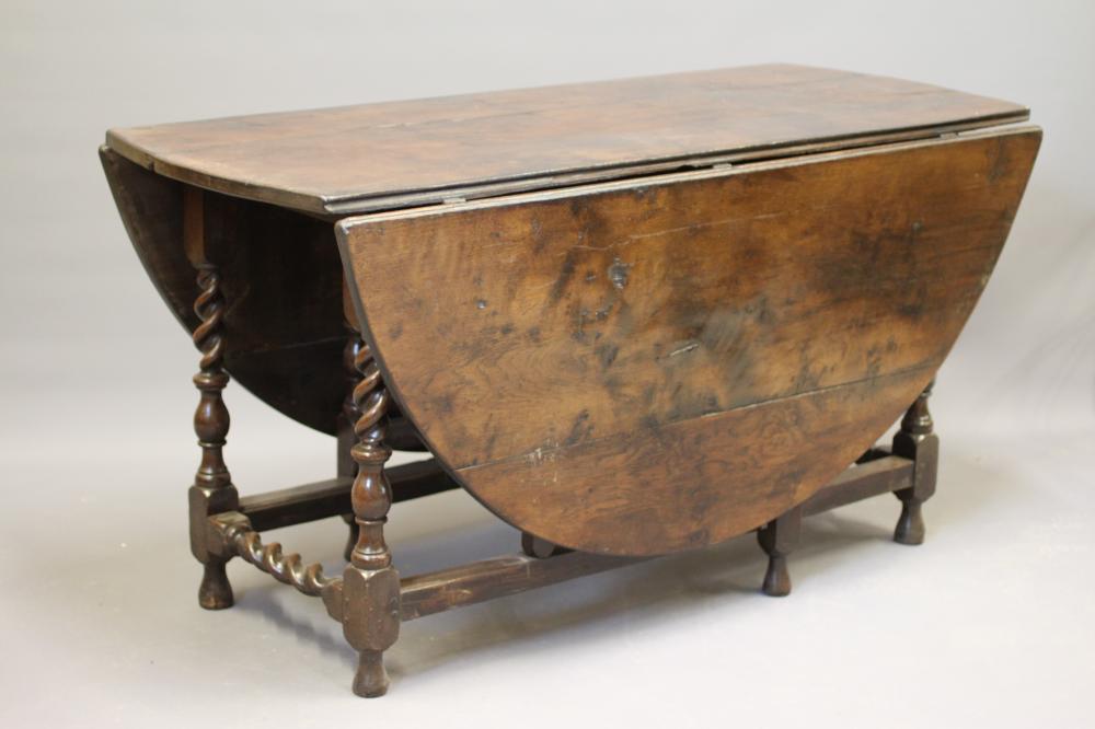 AN OAK GATELEG DINING TABLE Image