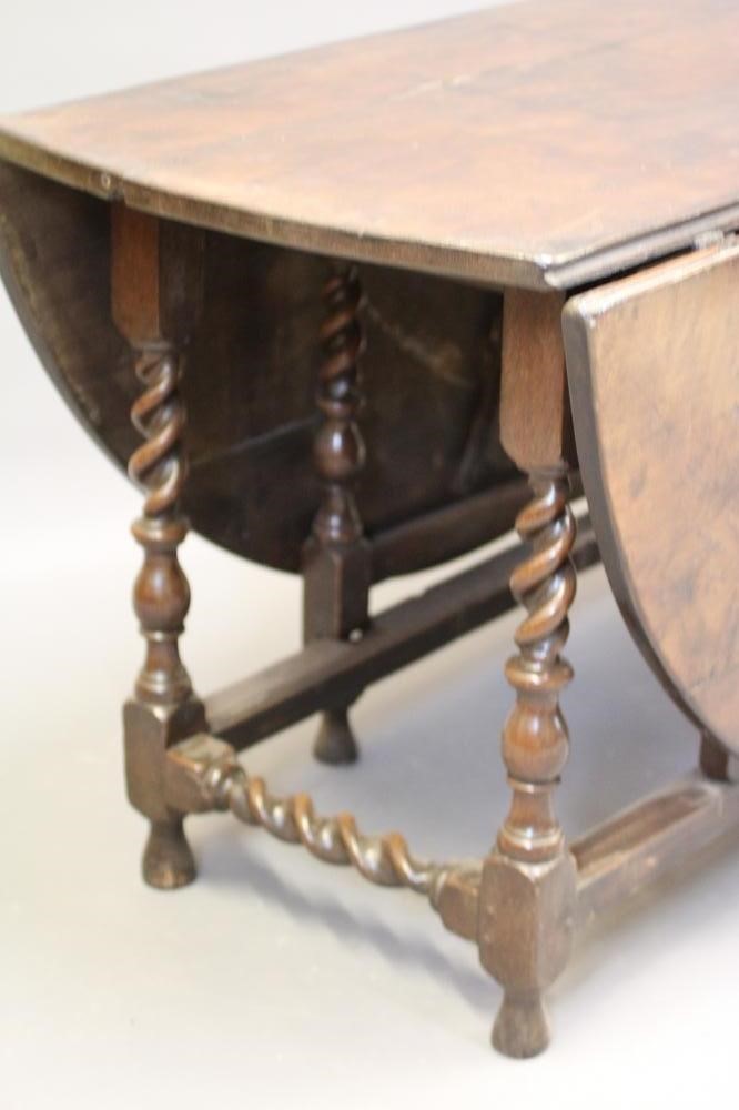 AN OAK GATELEG DINING TABLE Image