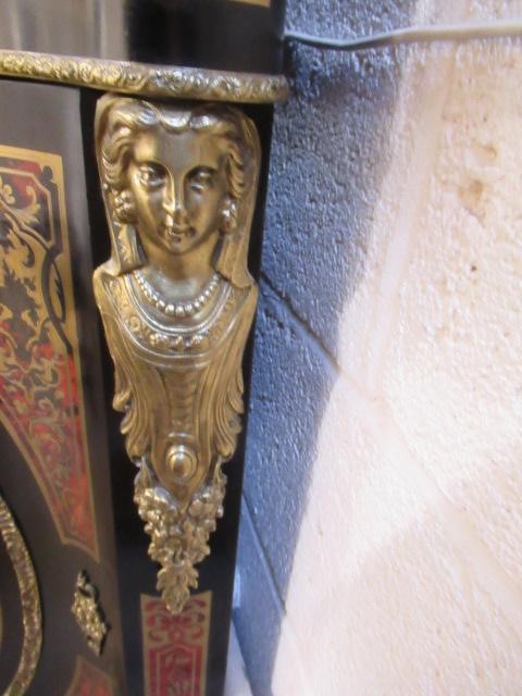 A RED BOULLE CORNER CABINET Image