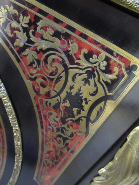 A RED BOULLE CORNER CABINET Image