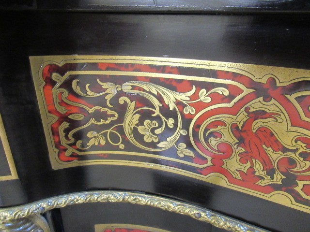 A RED BOULLE CORNER CABINET Image