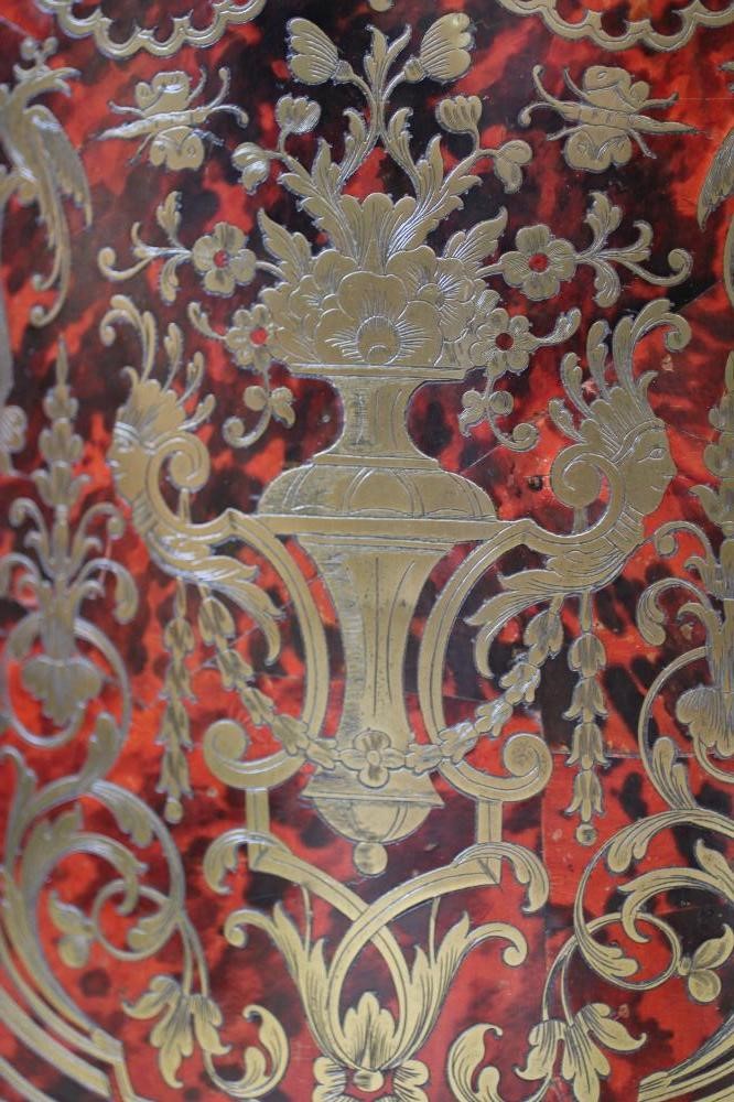 A RED BOULLE CORNER CABINET Image