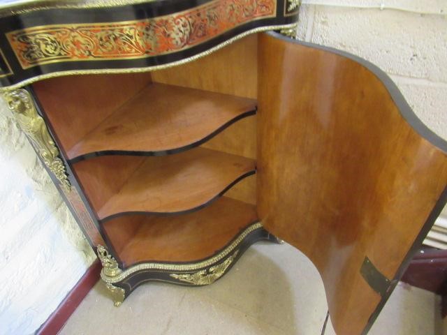A RED BOULLE CORNER CABINET Image