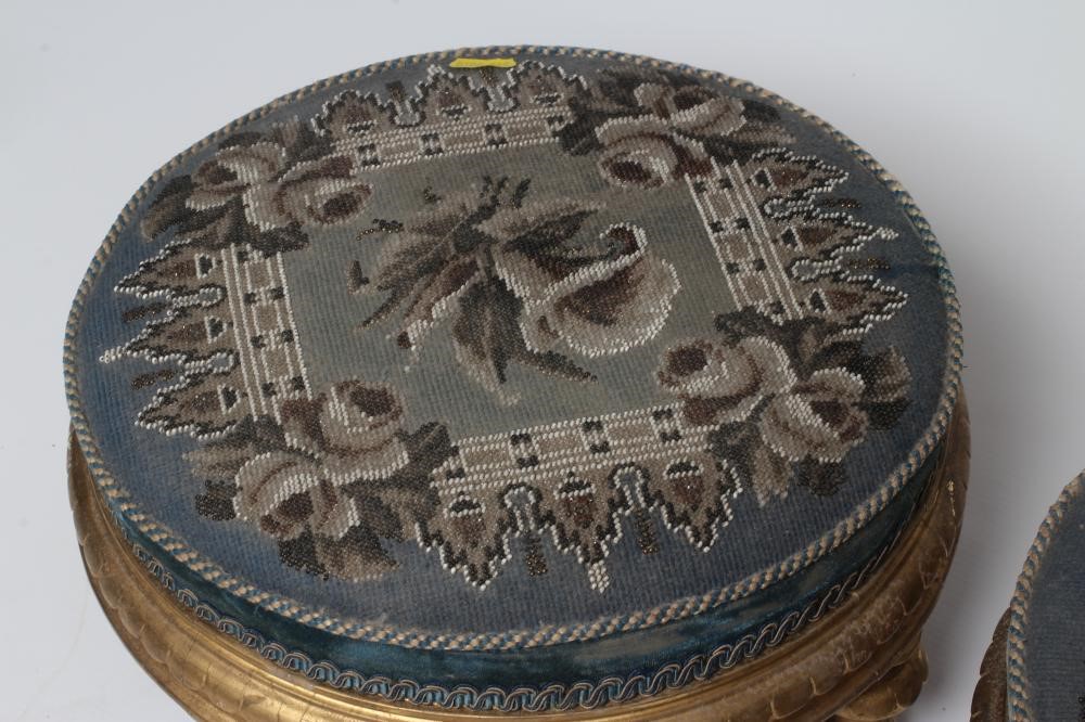 A PAIR OF EARLY VICTORIAN GILT WOOD FOOT STOOLS, of circular form upholstered in floral beadwork and Image