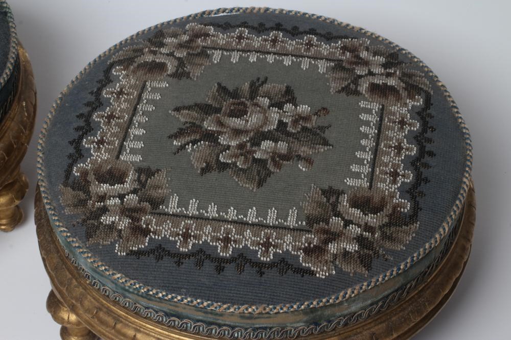 A PAIR OF EARLY VICTORIAN GILT WOOD FOOT STOOLS, of circular form upholstered in floral beadwork and Image