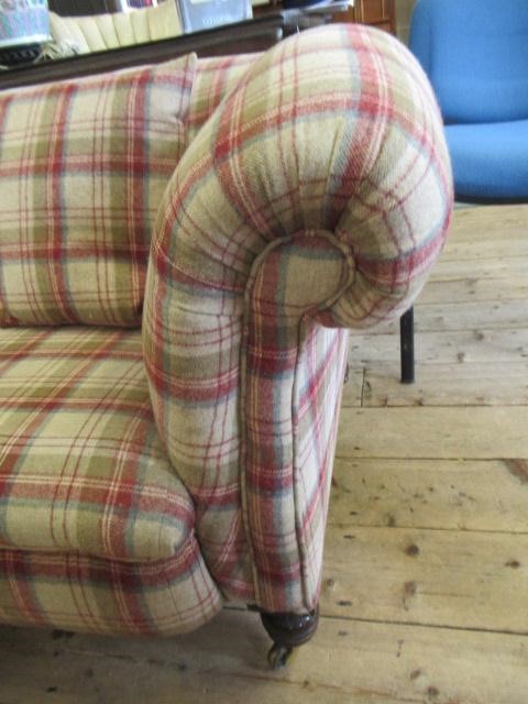 A VICTORIAN WALNUT FRAMED CHESTERFIELD SOFA, upholstered in wool tartan, raised on turned legs with Image