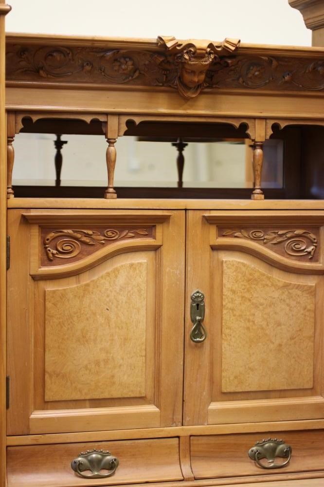 A VICTORIAN STRIPPED WALNUT TRIPLE WARDROBE comprising a pair of hanging compartments each with Image