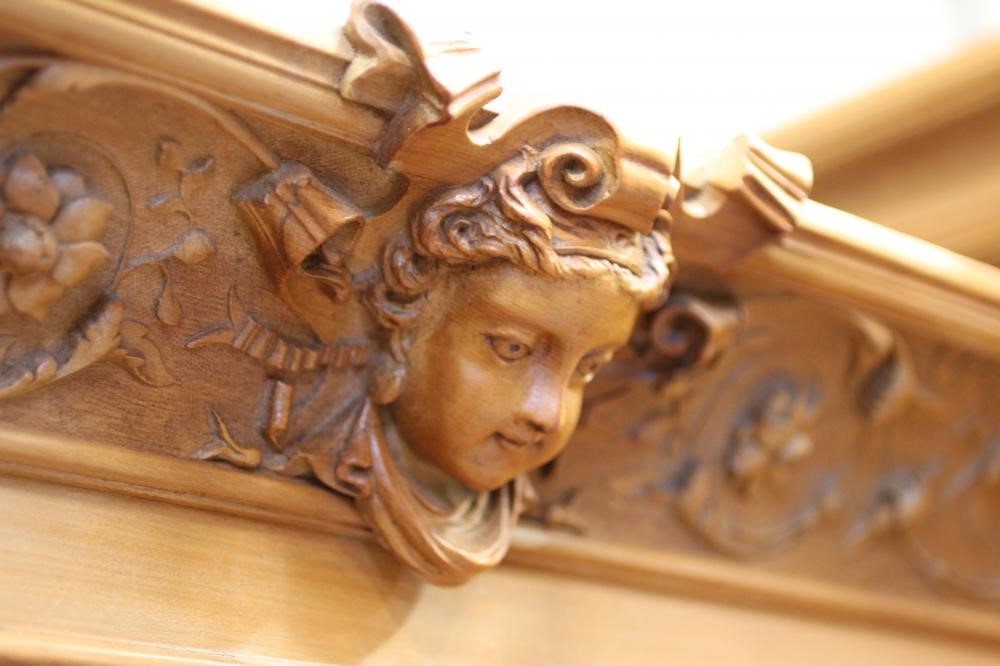 A VICTORIAN STRIPPED WALNUT TRIPLE WARDROBE comprising a pair of hanging compartments each with Image