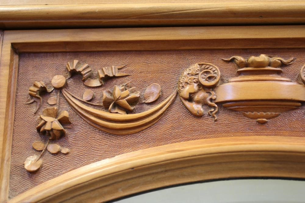 A VICTORIAN STRIPPED WALNUT TRIPLE WARDROBE comprising a pair of hanging compartments each with Image