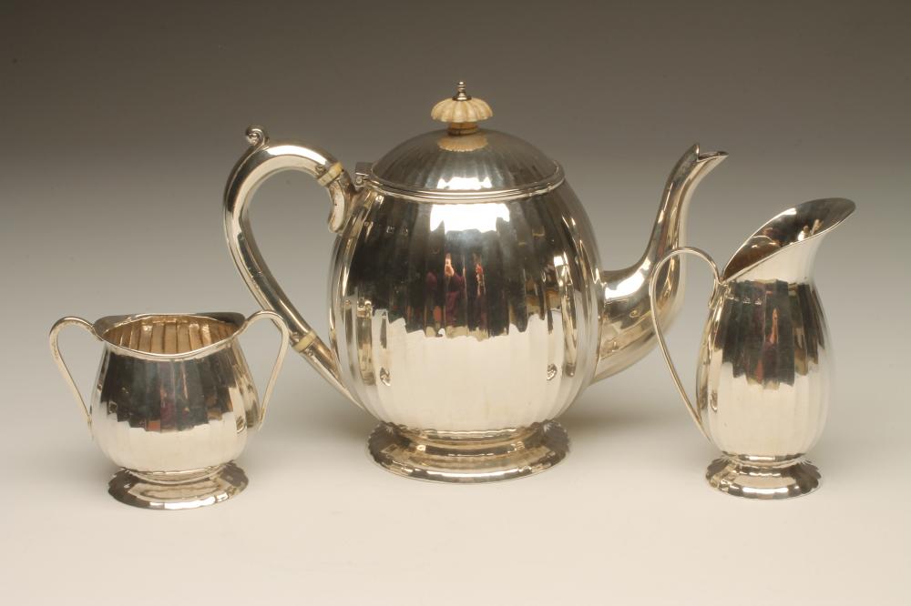 AN ART DECO THREE PIECE SILVER TEA SERVICE Image