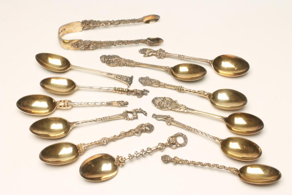 A MATCHED AND COMPOSITE SET OF TWELVE FANCY SILVER GILT TEASPOONS AND SUGAR TONGS Image