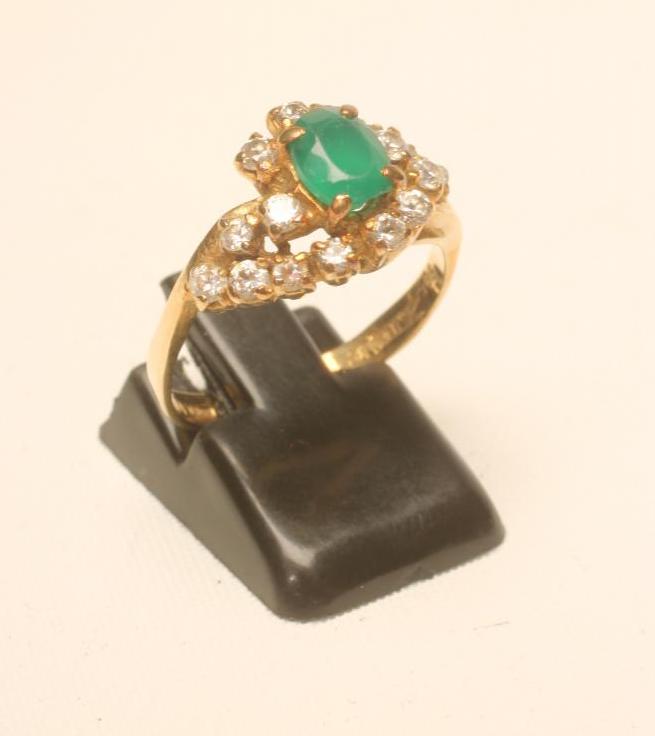 AN EMERALD AND DIAMOND COCKTAIL RING Image