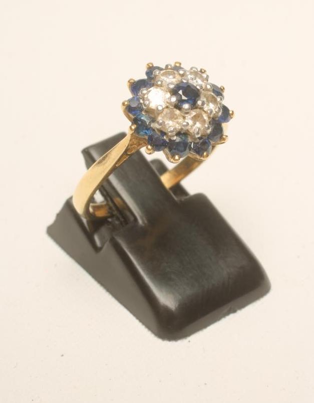 A SAPPHIRE AND DIAMOND CLUSTER RING Image